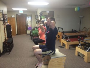 Two People Participating in a Chair Pilates Class
